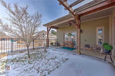 Front Covered Patio with wrought iron fence on two