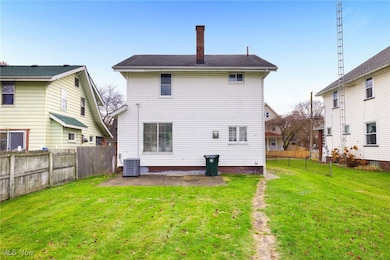 Back of house with a chimney, a fenced backyard, and a patio