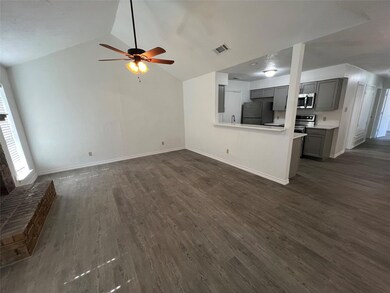 Unfurnished living room featuring high vaulted cei