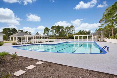 Community pool with a patio area, a fenced backyar