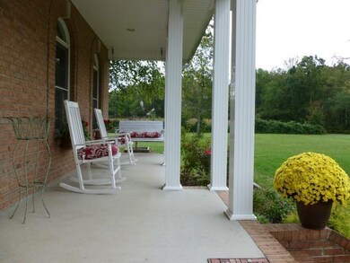 Side view of the front porch that has a sitting area.