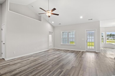 Interior space featuring ceiling fan, wood-type fl