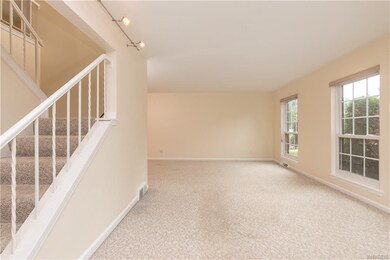 View of living room with stairs leading to second 