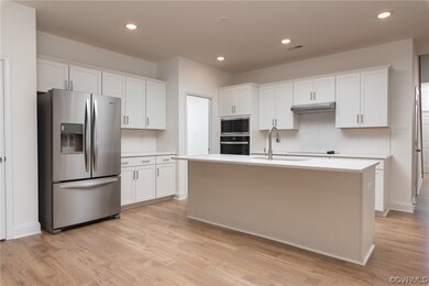 Kitchen with light hardwood / wood-style floors, t