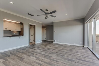 Living-dining area facing entry hall and kitchen