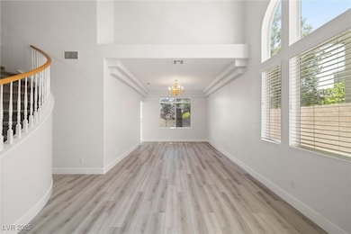 Unfurnished living room with stairway, wood finish