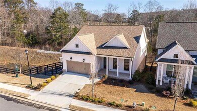 View of front of house featuring a porch and a gar