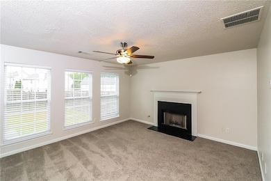 Unfurnished living room with a textured ceiling, l