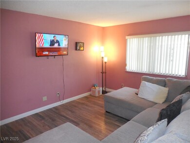 Living room with wood finished floors and baseboar