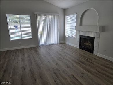 Unfurnished living room with vaulted ceiling, wood