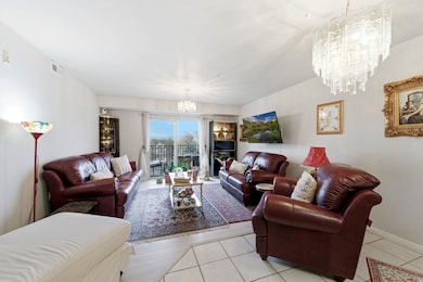 Living area featuring a chandelier and light tile patterned floors