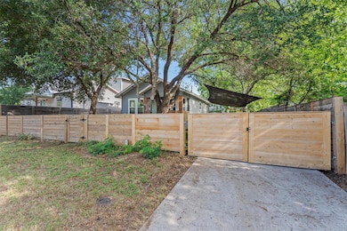 View of yard featuring a gate and fence