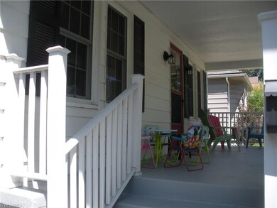 Front porch with overhead cover providing shade.