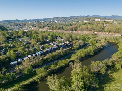 Nestled close to the French Broad River, the Greenway, the River Arts District, Downtown Asheville (left horizon), Mission Hospital (right horizon) and those magnificent Blue Ridge Parkway Mountains!