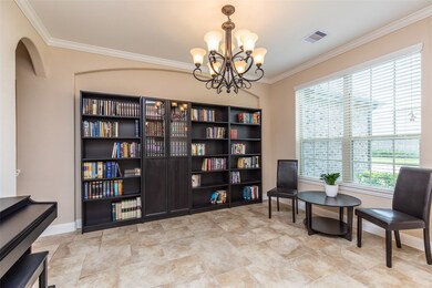Large formal dining room with crown molding and designer fixture.