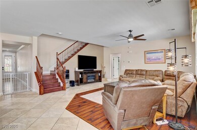 Family room with ceiling fan and light and tile fl