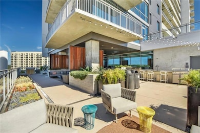 View of patio / terrace featuring a balcony, a gr