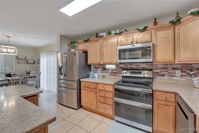 Kitchen featuring hanging light fixtures, light ti