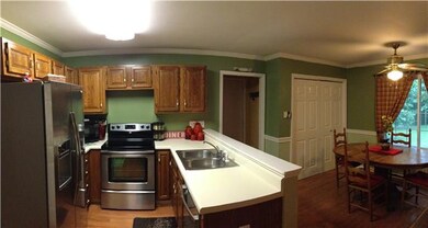 KITCHEN W/STAINLES STEEL APPLIANCES, AND SPACIOUS EAT-IN AREA AND DOOR TO DECK FOR THOSE GRILLING DAYS
