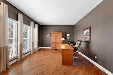 Home office with wood floors. Large picture window