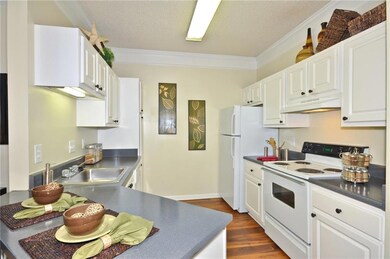Kitchen featuring white appliances, white cabinets