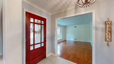 Entrance foyer featuring crown molding, hardwood /