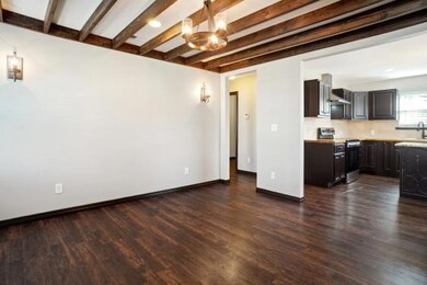 Unfurnished living room featuring , dark hardwood 