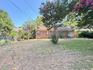 Rear view of house featuring a yard