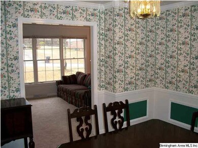 This dining room has hardwood flooring under carpe