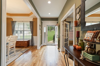 Well lit entryway with office and dining room on either side.