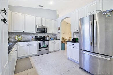 Granite counters and stone backsplash in huge kitc