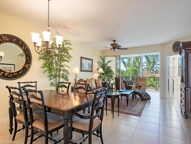 Tiled dining area with ceiling fan with notable chandelier
