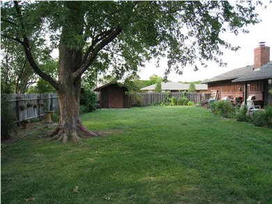 View Of Back - Trees, Storage Shed & Covered Patio