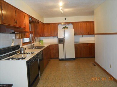 roomy L-shaped kitchen has an abundance of beautif