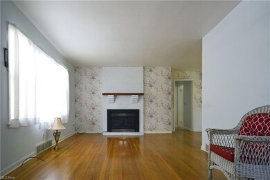 View of living room from the front door - fireplace has been converted to a gas fireplace. Seller will have a part replaced prior to title transfer. The gas is off at this time.