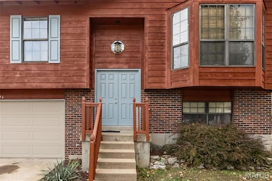 View of exterior entry featuring brick siding