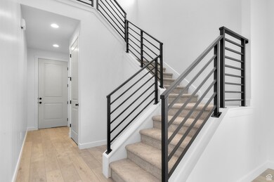 Staircase with wood-type flooring and recessed lighting
