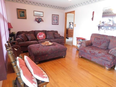 Your formal living room has beautiful hardwood flooring and abundant natural lighting.