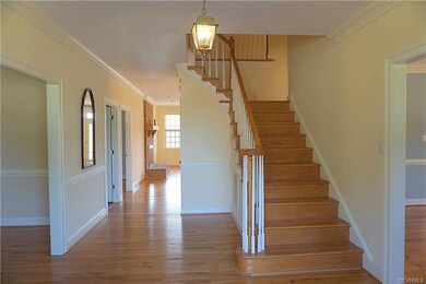Bright foyer with wood floors, full bathroom, and 