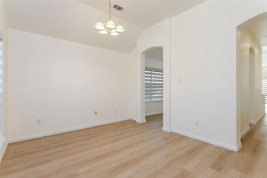 Empty room featuring lofted ceiling, a notable cha