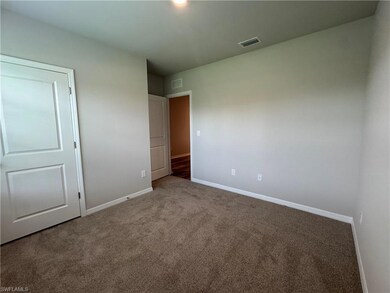 Unfurnished bedroom with carpet flooring and baseboards