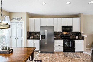 Large open concept kitchen... with stainless refrigerator.