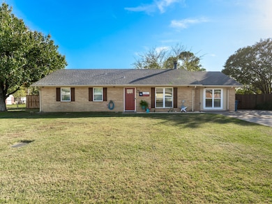 Single story home featuring a shingled roof and brick siding