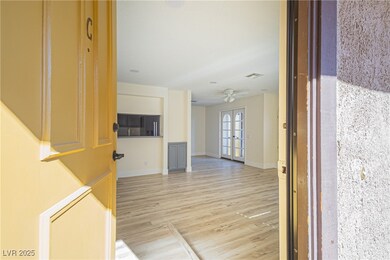Corridor featuring french doors and light wood-type flooring