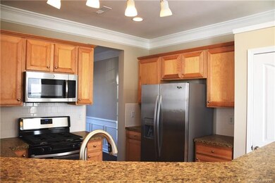 Kitchen features stainless appliances including bu