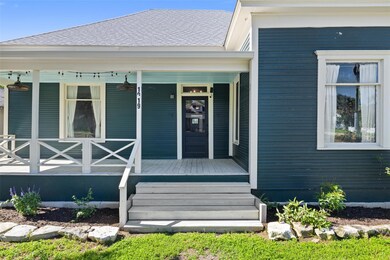 Doorway to property with a shingled roof and cove