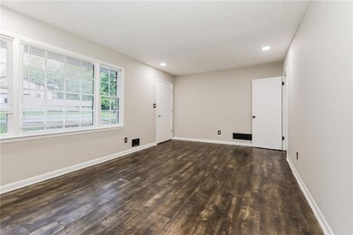 Empty room with wood finished floors, baseboards, 