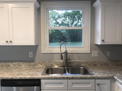 View of private back yard from kitchen. Upgraded plumbing fixtures