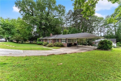 View of front of property featuring a chimney, dri