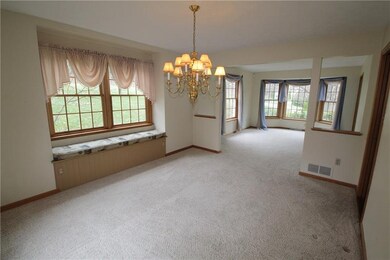 The dining room has a cozy window seat with storag